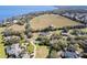 Expansive land with a lake view is dotted with trees, showcasing the estate's scale and waterfront charm at 5150 Banana Point Dr, Okahumpka, FL 34762