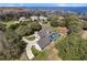Aerial view showcases the home, screened pool, and backyard with lake in the distance at 5150 Banana Point Dr, Okahumpka, FL 34762