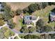 Aerial view highlighting a secluded home with a screened pool, mature trees and a private driveway at 5150 Banana Point Dr, Okahumpka, FL 34762
