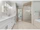 Bright bathroom with double sinks and bright walk-in shower at 5150 Banana Point Dr, Okahumpka, FL 34762