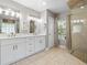 Bathroom featuring a walk-in shower, double sinks, and neutral colors at 5150 Banana Point Dr, Okahumpka, FL 34762