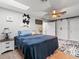 Cozy bedroom featuring a wood ceiling fan, sliding closet doors, and unique cowhide wall decor at 5150 Banana Point Dr, Okahumpka, FL 34762