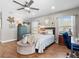 Comfortable bedroom with hardwood floors, natural light, and decorative turtle themed decorations at 5150 Banana Point Dr, Okahumpka, FL 34762