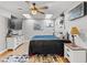 Bright bedroom with hardwood floors, ceiling fan and a large flat screen TV at 5150 Banana Point Dr, Okahumpka, FL 34762