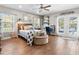 Inviting bedroom with a ceiling fan, hardwood floors, and access to the outdoor pool area at 5150 Banana Point Dr, Okahumpka, FL 34762