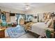 Cozy bedroom featuring a ceiling fan, neutral walls, area rug, and eclectic decor at 5150 Banana Point Dr, Okahumpka, FL 34762