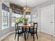 Cozy breakfast nook with views of the screened-in pool, provides a relaxing space to enjoy meals at 5150 Banana Point Dr, Okahumpka, FL 34762