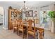 Elegant dining room featuring a large wooden table, chairs, a chandelier, and a decorative hutch at 5150 Banana Point Dr, Okahumpka, FL 34762