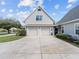 A two-car garage with gabled roof is attached to this well maintained home with ample parking space at 5150 Banana Point Dr, Okahumpka, FL 34762