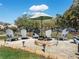 Outdoor area has seating around a cozy stone firepit and charming landscaping at 5150 Banana Point Dr, Okahumpka, FL 34762