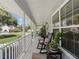 Inviting front porch with rocking chairs and decorative plants, perfect for relaxation at 5150 Banana Point Dr, Okahumpka, FL 34762