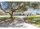 Beautiful home with a long driveway and a charming tree swing in the front yard at 5150 Banana Point Dr, Okahumpka, FL 34762