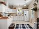 A cozy kitchen featuring white cabinets, wood countertops, white appliances, and a window over the sink at 5150 Banana Point Dr, Okahumpka, FL 34762