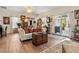 Bright living room with decorative pillows, an antique chest and hardwood floors at 5150 Banana Point Dr, Okahumpka, FL 34762