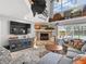 Bright living room features a stone fireplace, backyard views, and is perfect for relaxing and entertaining at 5150 Banana Point Dr, Okahumpka, FL 34762