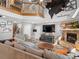 Cozy living room features high ceilings, a stone fireplace, and a loft, perfect for relaxation at 5150 Banana Point Dr, Okahumpka, FL 34762