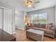 Living room featuring a plush couch, ottoman, and large window at 5150 Banana Point Dr, Okahumpka, FL 34762