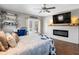 This bedroom features a fireplace, TV, and exit to the backyard pool at 5150 Banana Point Dr, Okahumpka, FL 34762