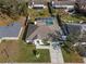 Aerial view of home with fenced yard and screened pool in a quiet neighborhood at 5173 Clarion Oaks Dr, Orlando, FL 32808