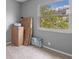 Bedroom with a large window allowing ample light into the space with grey walls and neutral-toned carpet at 5173 Clarion Oaks Dr, Orlando, FL 32808