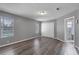 Bedroom featuring hardwood flooring, white closet doors, and windows allowing natural light to illuminate the interior at 5173 Clarion Oaks Dr, Orlando, FL 32808