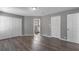 Bedroom featuring hardwood flooring, white closet doors, and view to adjacent bathroom at 5173 Clarion Oaks Dr, Orlando, FL 32808