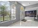 Bright entryway featuring tiled flooring, decorative lighting, and a glass front door at 5173 Clarion Oaks Dr, Orlando, FL 32808