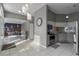 Open-concept living space with tile flooring and a view into the modern kitchen at 5173 Clarion Oaks Dr, Orlando, FL 32808