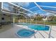 Outdoor pool area featuring a hot tub, screened in enclosure, and patio furniture at 5173 Clarion Oaks Dr, Orlando, FL 32808