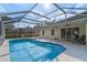 Backyard pool area with screened-in lanai, showcasing a spa and lounging area perfect for relaxation at 5173 Clarion Oaks Dr, Orlando, FL 32808