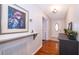 Inviting hallway with hardwood floors, decorative painting and a front door with leaded glass at 5214 E Kaley St, Orlando, FL 32812