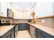 Well-lit kitchen with stainless steel appliances, custom cabinetry, and tile backsplash at 5214 E Kaley St, Orlando, FL 32812