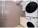 Convenient laundry room with a stacked washer and dryer set and neutral walls at 5214 E Kaley St, Orlando, FL 32812