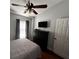 Bedroom featuring a TV, window with blinds, a ceiling fan and a dresser at 5337 Watervista Dr, Orlando, FL 32821