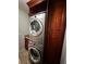 Laundry room featuring stacked washer and dryer and cherry cabinets at 5337 Watervista Dr, Orlando, FL 32821