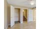 Bedroom featuring two closets and an ensuite bathroom with beige walls and tile flooring at 6142 Westgate Dr # 102, Orlando, FL 32835