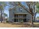 Exterior view of home with multi-level porch, landscaping, and stairs at 6142 Westgate Dr # 102, Orlando, FL 32835