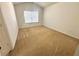 Carpeted bedroom with window and natural light at 6292 Twain Street # 108, Orlando, FL 32835