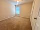 Bedroom with carpet and a window at 6292 Twain Street # 108, Orlando, FL 32835