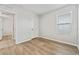 Bright bedroom with wood-look flooring, a window, and a closet door at 6745 Huntleigh Hammock Rd, Harmony, FL 34773