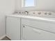 The laundry room has a modern washer and dryer for residents to utilize at 6745 Huntleigh Hammock Rd, Harmony, FL 34773