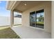 Covered patio with sliding glass door leading to the indoors at 6745 Huntleigh Hammock Rd, Harmony, FL 34773