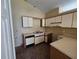 Functional kitchen featuring laminate countertops and white cabinetry, ready for updates at 6856 Ebans Bnd, Orlando, FL 32807