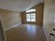 Spacious room featuring a vaulted ceiling and large window for natural light at 6856 Ebans Bnd, Orlando, FL 32807