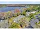 Aerial view of condos next to lake, showing mature trees and parking at 705 Northlake Dr # 705, Sanford, FL 32773