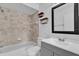 Bathroom featuring tiled shower over tub, neutral walls and gray vanity with modern hardware at 705 Northlake Dr # 705, Sanford, FL 32773