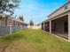 Large backyard featuring a well-maintained lawn, privacy fencing, and screened-in porch at 739 Annabell Ridge Rd, Minneola, FL 34715