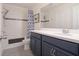 Bathroom features a single vanity and shower-tub combination with blue-patterned shower curtain at 739 Annabell Ridge Rd, Minneola, FL 34715