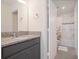 Bathroom with granite countertop single vanity, shower-tub combination and white floral shower curtain at 739 Annabell Ridge Rd, Minneola, FL 34715