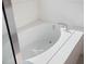 Bright white bathroom featuring a soaking tub with a clear glass shower screen at 739 Annabell Ridge Rd, Minneola, FL 34715